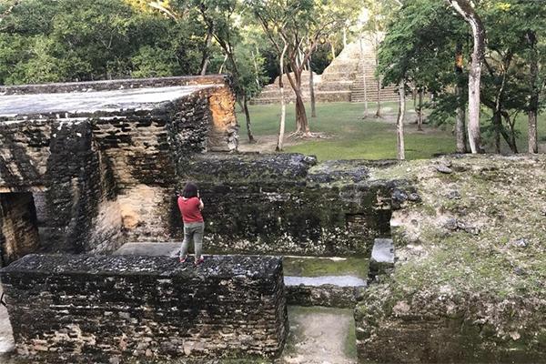 Jiawei Huang, a doctoral student in geography, conducts field work at the Cahal Pech Maya ruins in Belize, Central America.